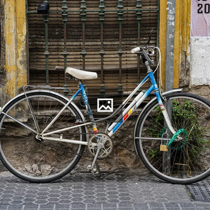 Vintage bicycle by worn building