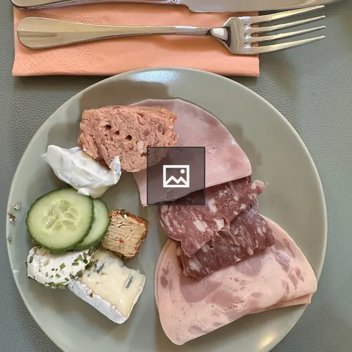 Pork slices on a plate with cucumber