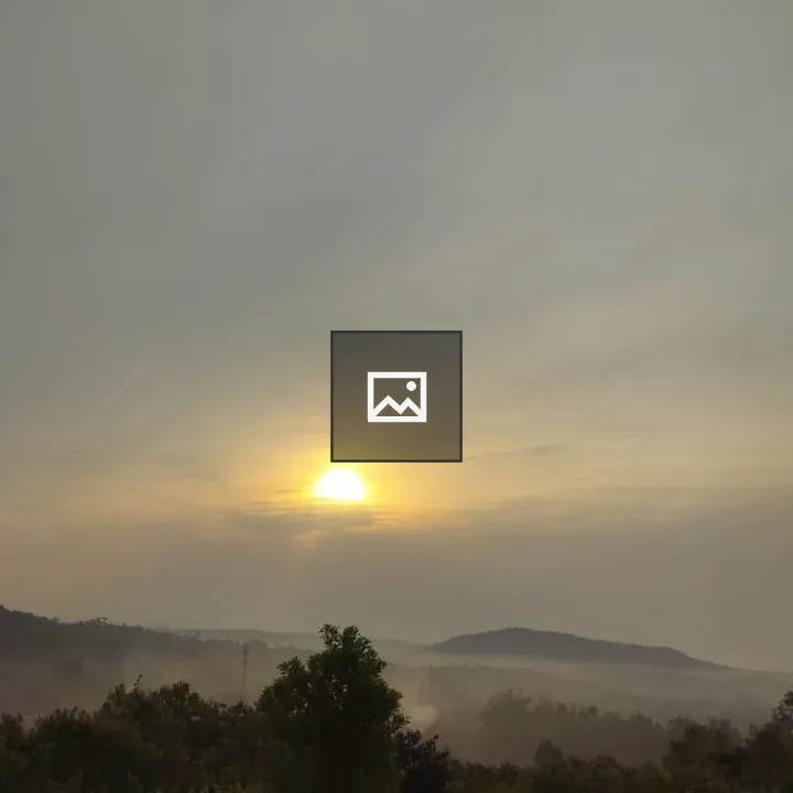 Sunrise over misty hills