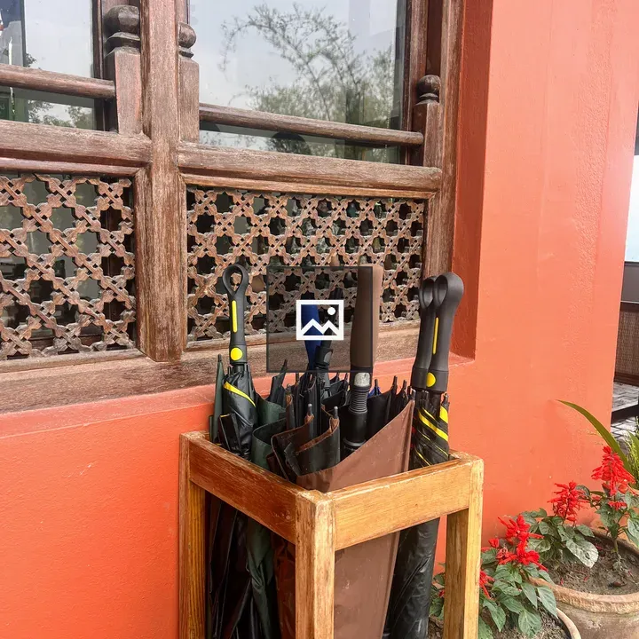 Umbrella Stand by Orange Wall