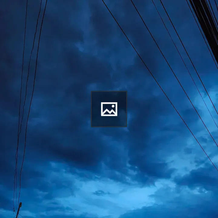 Dark blue sky with swirling clouds and power lines