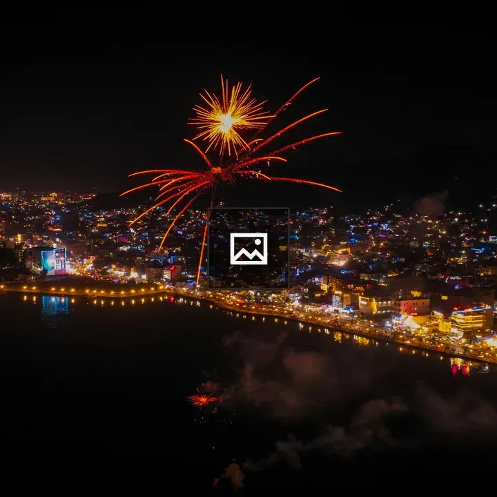 Fireworks over city by water
