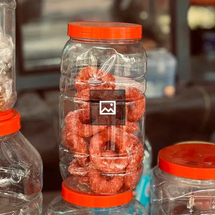 Transparent jars of orange honey candy