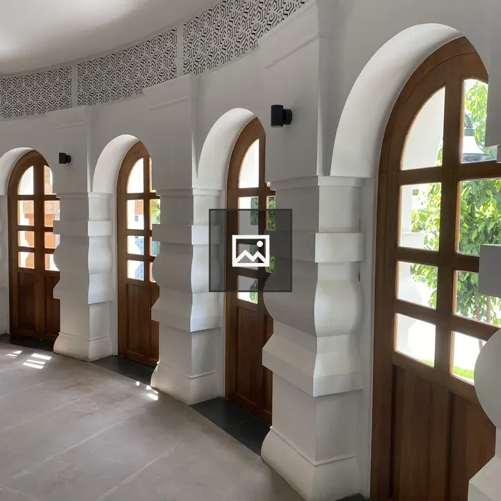 Curved interior hallway with arched doorways