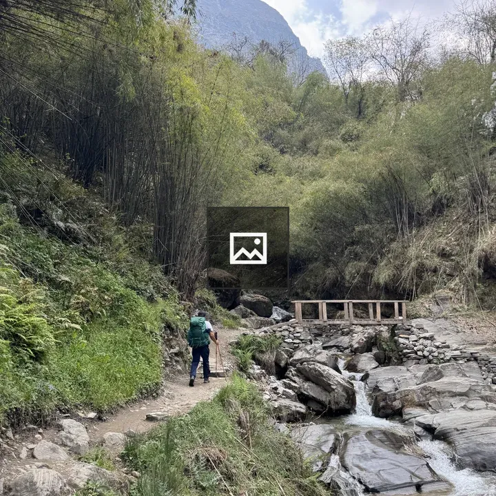 Trekker with Green Backpack in Nepal Valley