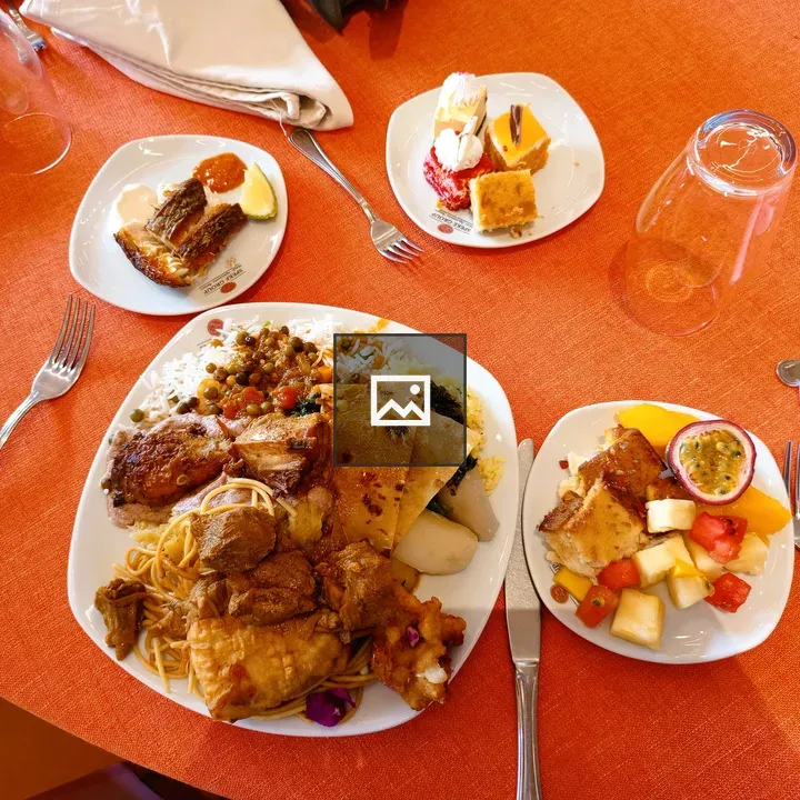 Orange tablecloth with plated foods