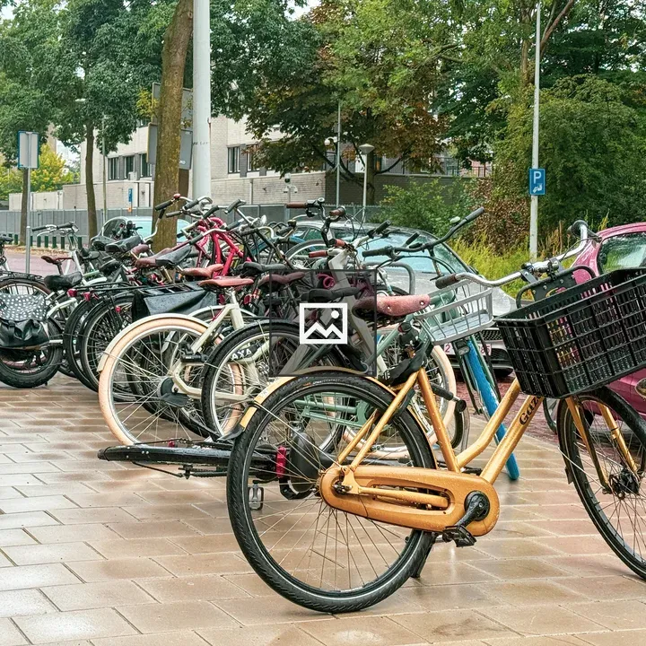 Row of bicycles on brick sidewalk