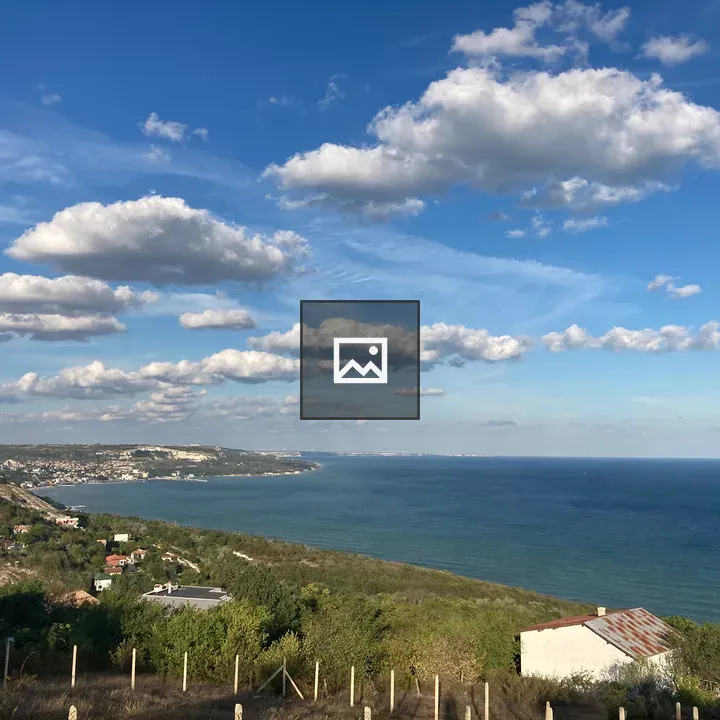 Coastal hillside with houses and sea