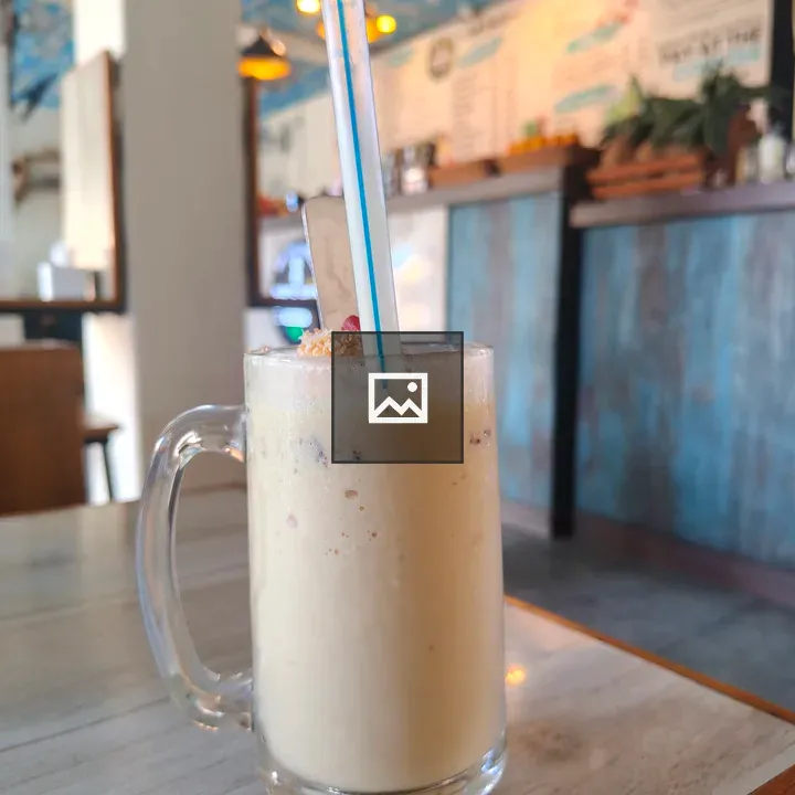 Glass mug with creamy beverage