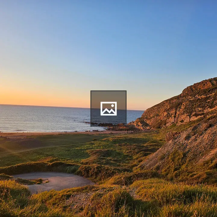 Cliff with vegetation at sunset