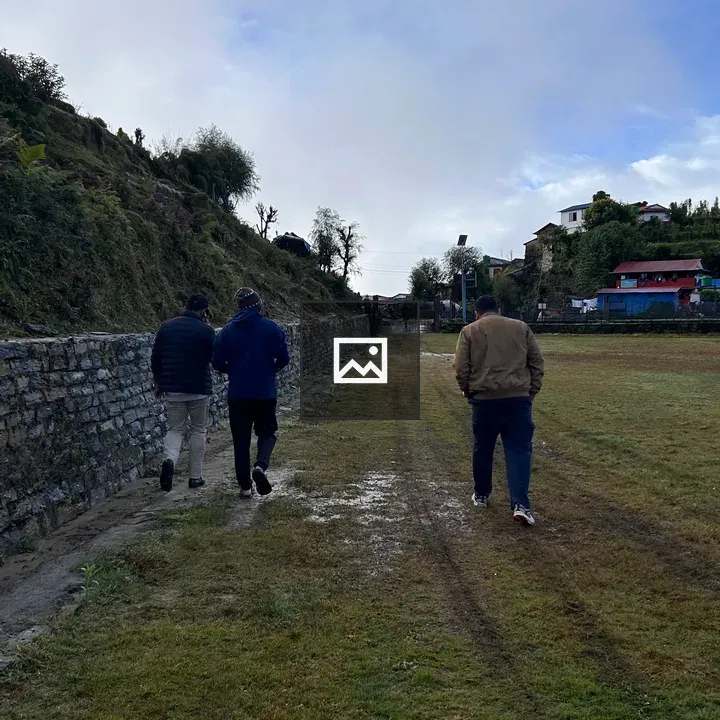 Three walkers on grassy path