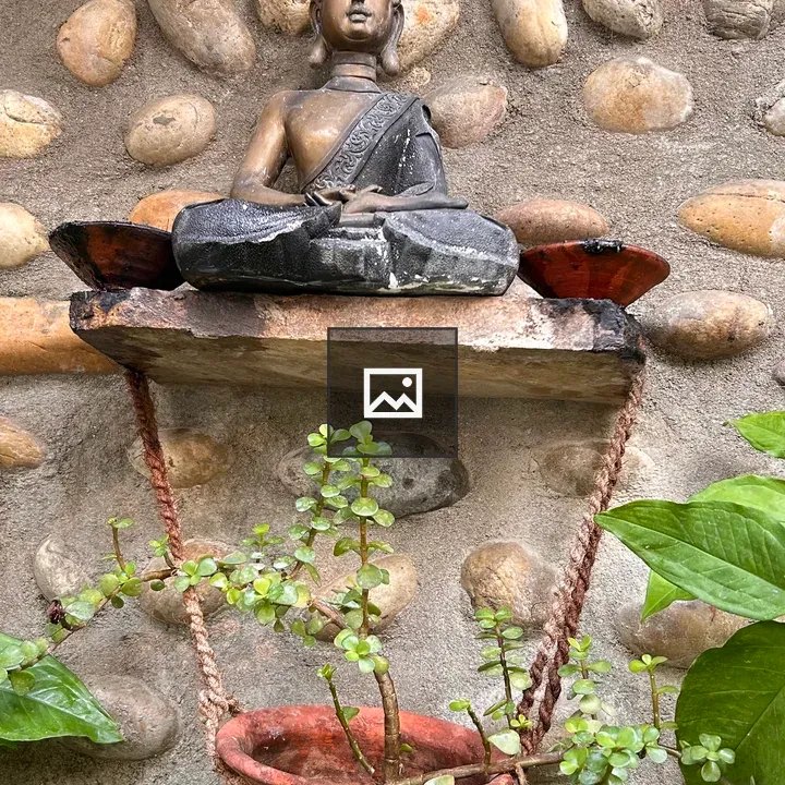 Buddha statue on wooden shelf