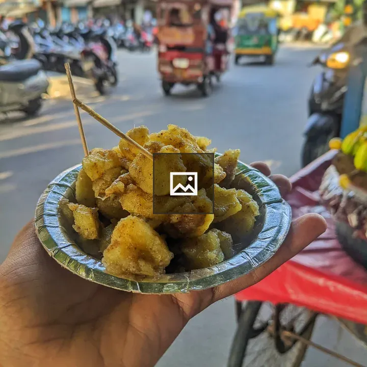 Hand with fried sweet potato snacks