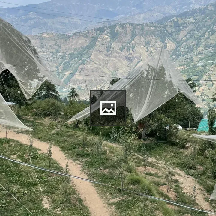 Mountain path with nets in field