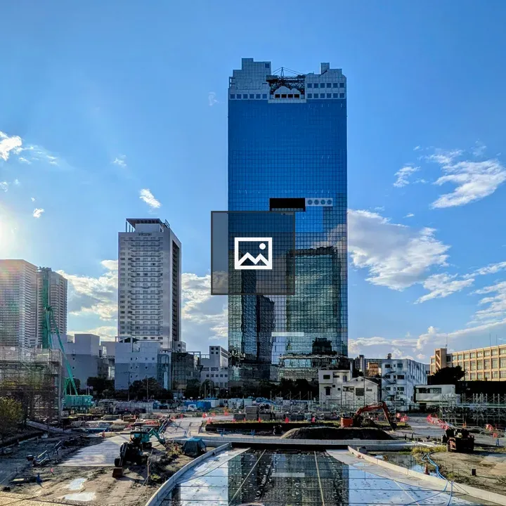 Glass skyscraper with construction foreground