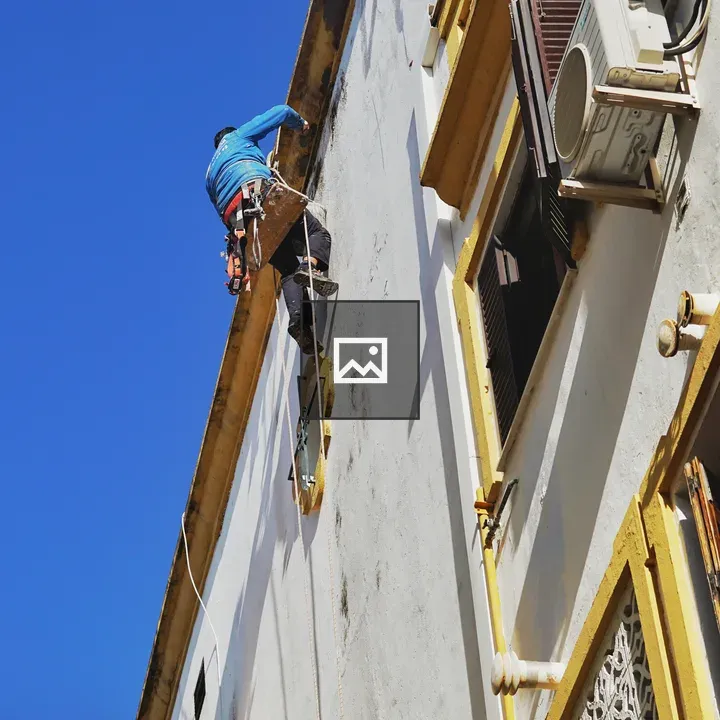 Painter on rope repair exterior