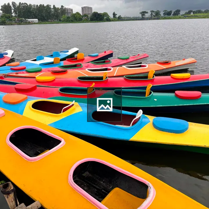 Row of colorful kayaks on lake