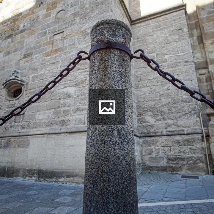 Stone post with chain near cathedral