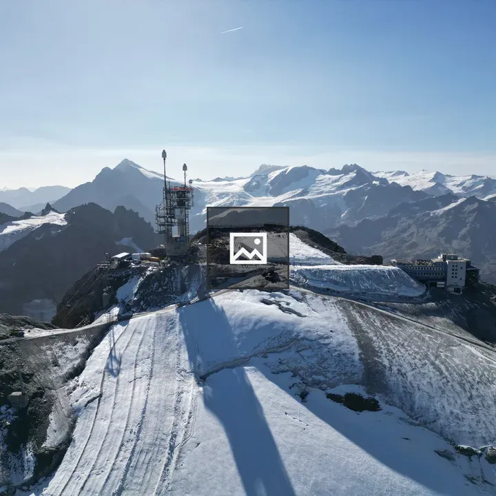 Snow-covered mountain peak with alpine structures