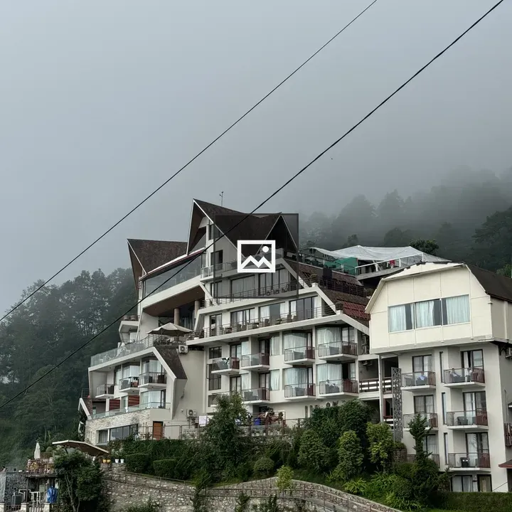 Apartment building with hillside fog