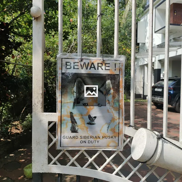 Beware sign with Husky guard dog