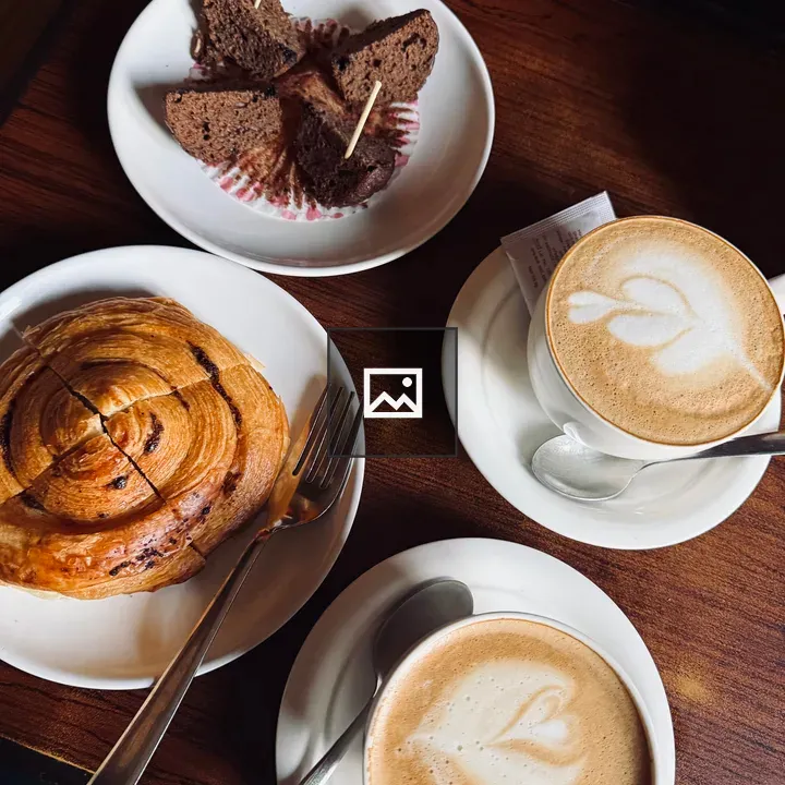 Overhead cappuccino and cake on table