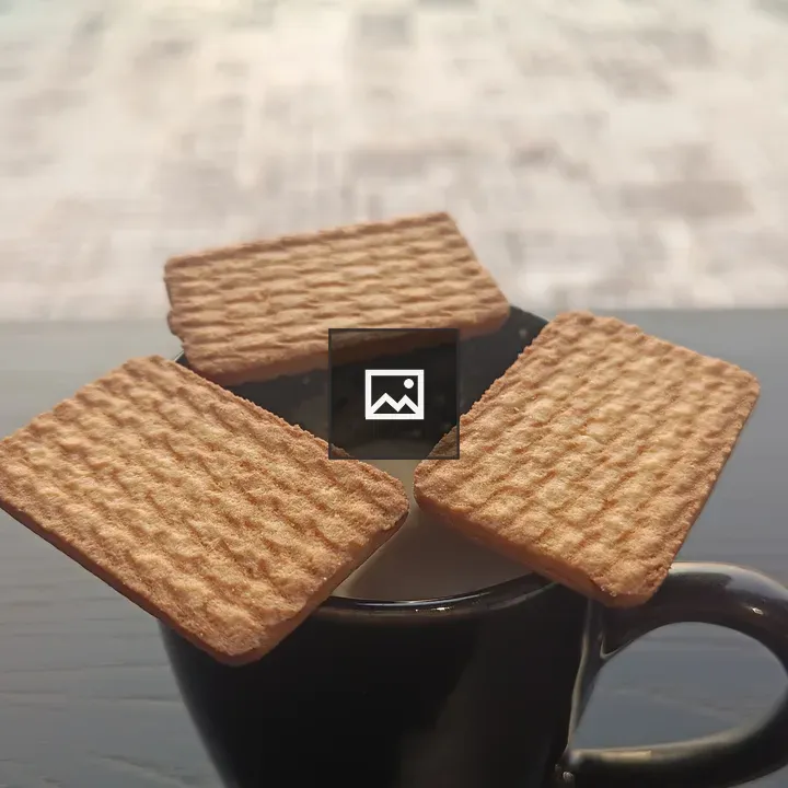 Three biscuits on black tea cup