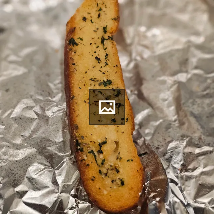 Garlic bread slice on foil
