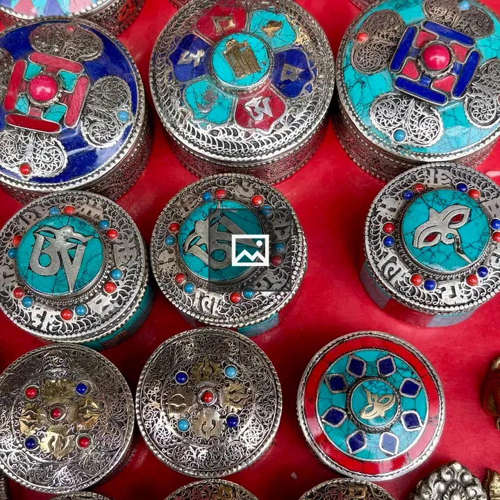 Circular ornate boxes with silver patterns