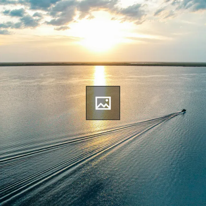 Airboat on a lake at sunset