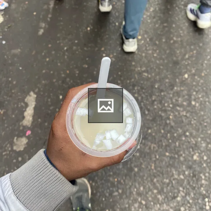 Hand holding coconut water cup