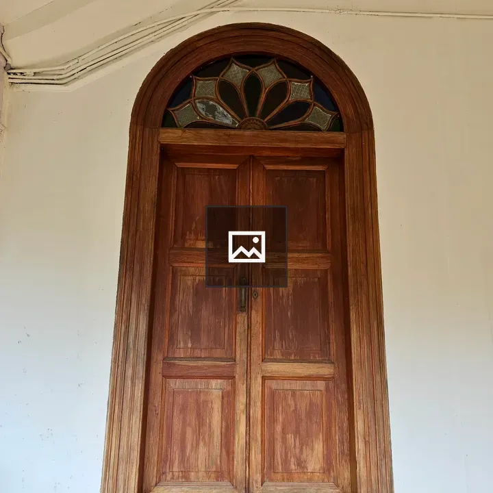 Wooden door with decorative glass arch