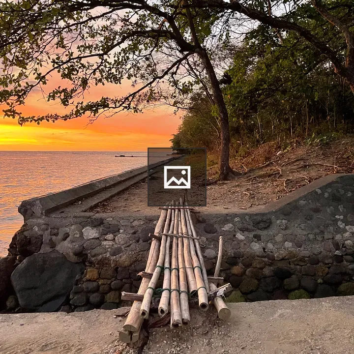 Sunset over seaside bamboo bridge
