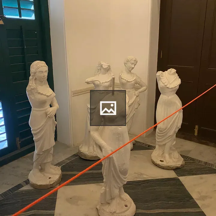 Four white statues indoors