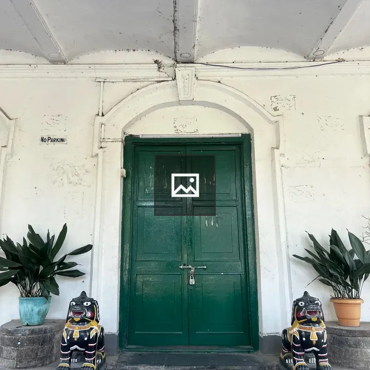 Green double door on white wall