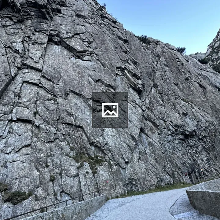 Winding light gravel path beside cliff