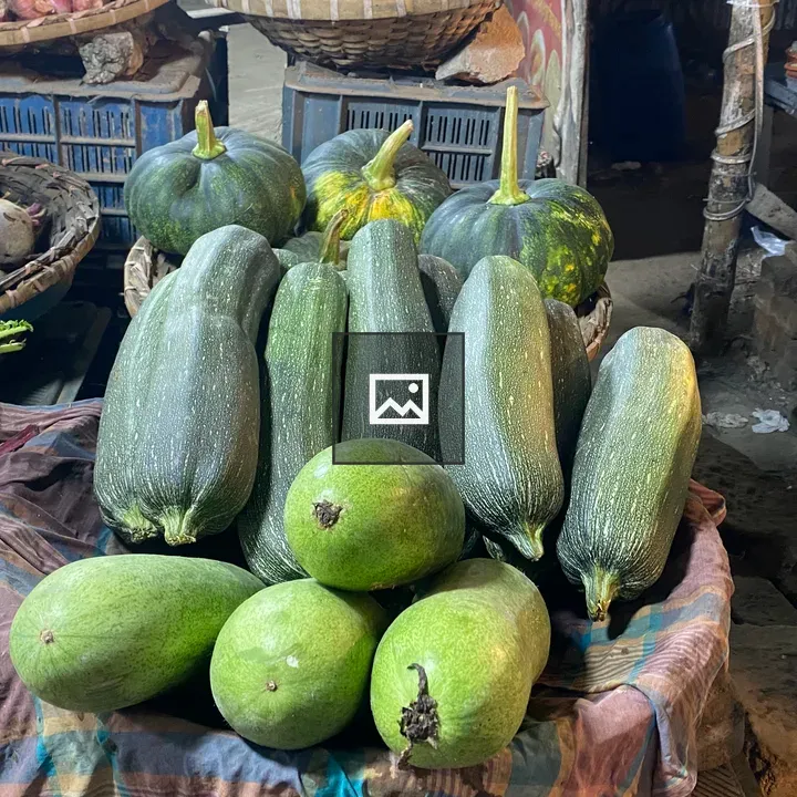 Green zucchinis and squash at market stall