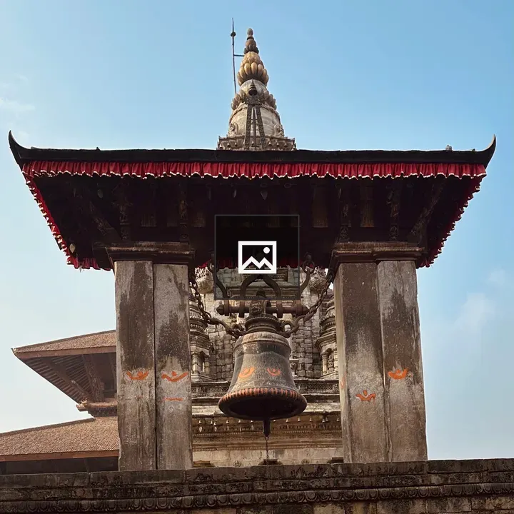 Ornate stone structure with bell