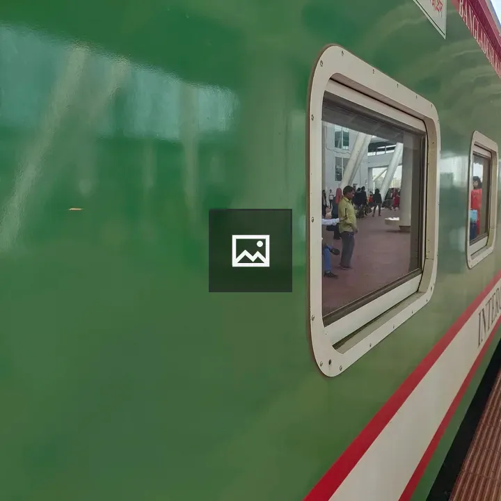 Side view of green train at platform