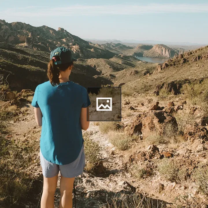Person hiking overlooking rocky desert landscape
