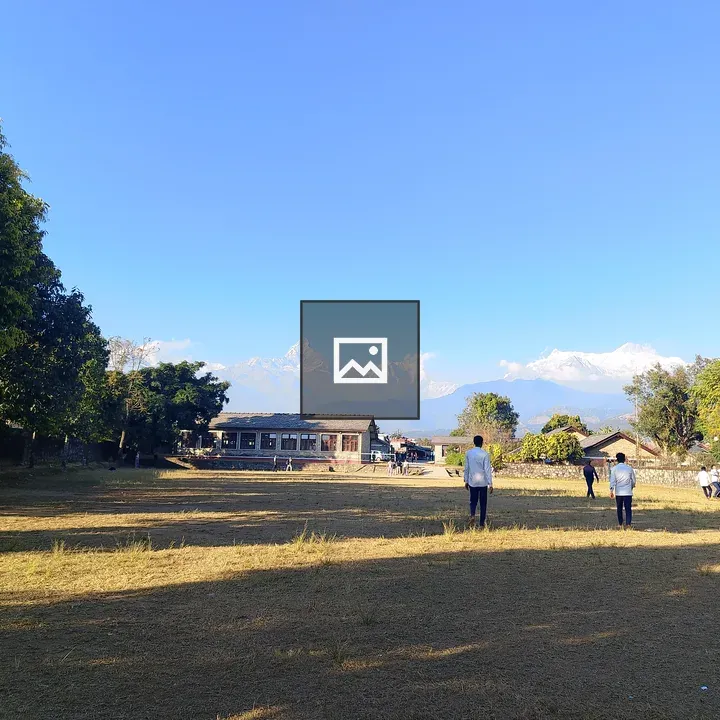 Boys Playing Ball in Grassy Playground