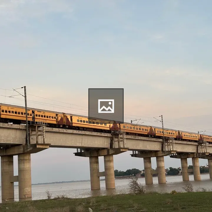 Train on bridge at sunset