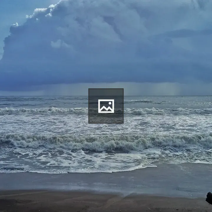 Beach in the rain seen from shore