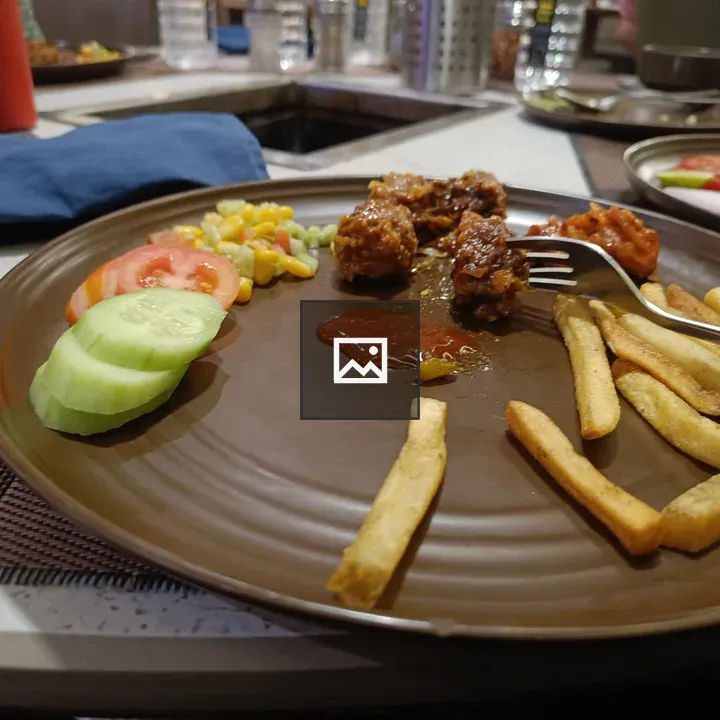 Brown plate with mixed food items