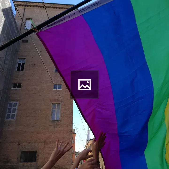 Hands with rainbow flag and city skyline