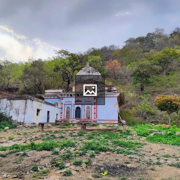 Old shrine amidst trees and clouds