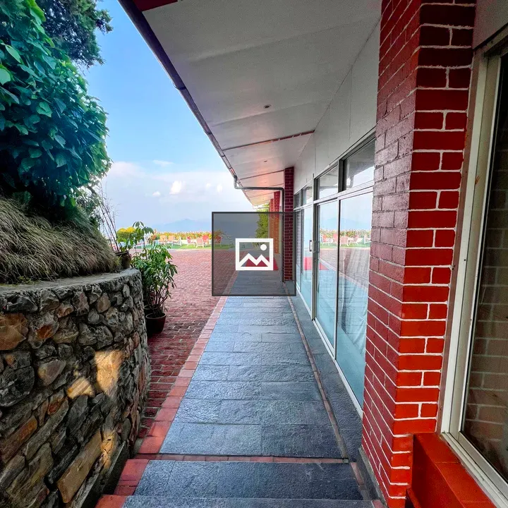 Outdoor walkway beside red brick building