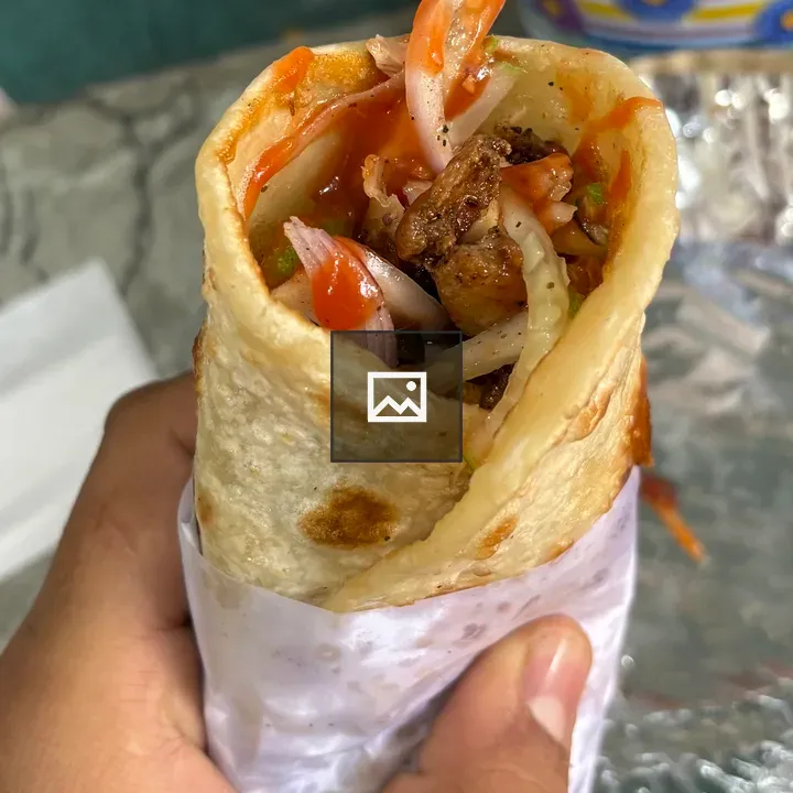 Hand holding burrito wrap