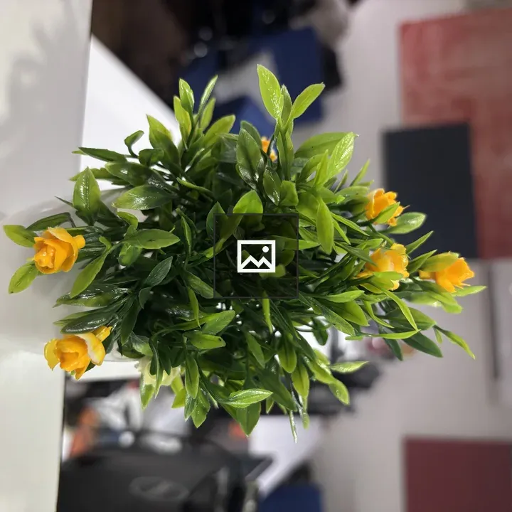 Artificial plant in white pot