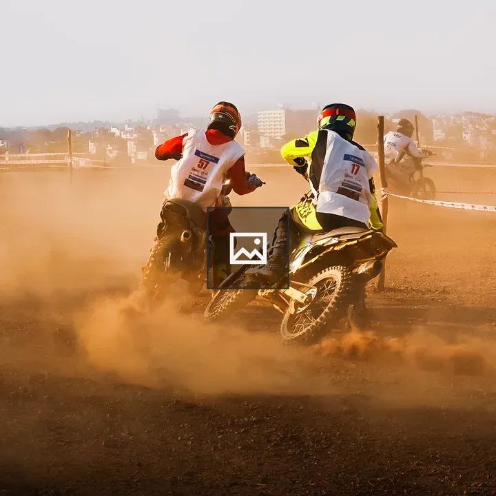 Two motocross riders at dirt track